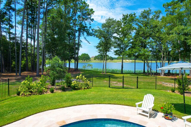 view of pool with a water view, a yard, and a patio area