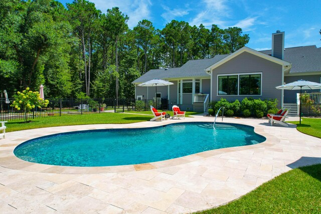 view of swimming pool featuring a yard and a patio