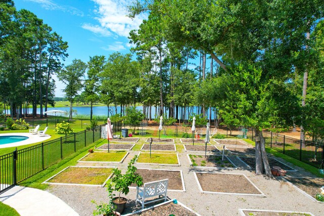 view of community featuring a yard and a water view