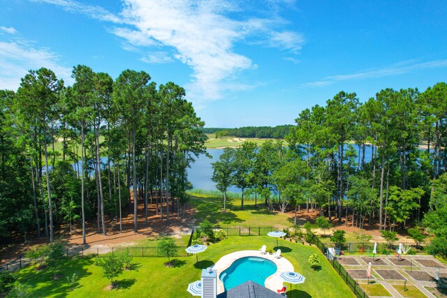 view of pool with a water view and a yard