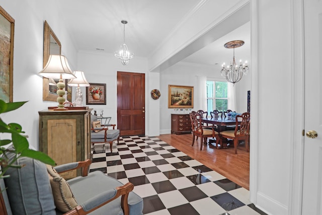 entrance foyer featuring crown molding and a chandelier