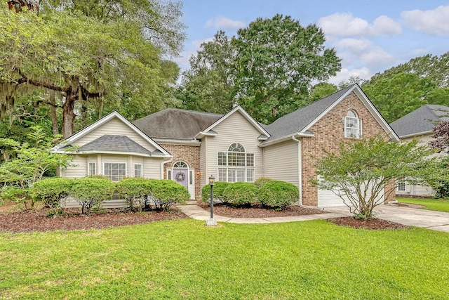 1148 Black Rush Cir, Mount Pleasant, SC 29466 - view of front facade with concrete driveway, brick siding, a front lawn, a garage, and roof with shingles