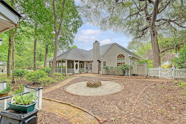 1148 Black Rush Cir, Mount Pleasant, SC 29466 - back of property with a gate, a chimney, and a sunroom