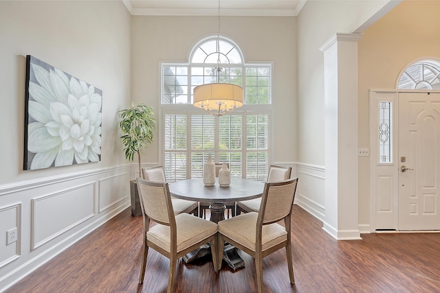 1148 Black Rush Cir, Mount Pleasant, SC 29466 - dining area featuring a chandelier, a decorative wall, dark wood-style floors, a wainscoted wall, and ornate columns