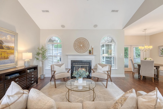 1148 Black Rush Cir, Mount Pleasant, SC 29466 - living area featuring wood finished floors, vaulted ceiling, a tile fireplace, baseboards, and a chandelier