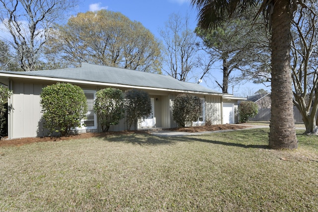 view of front of house with a garage and a front yard