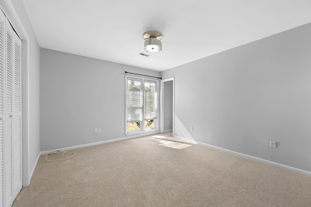 unfurnished bedroom with carpet flooring and a closet