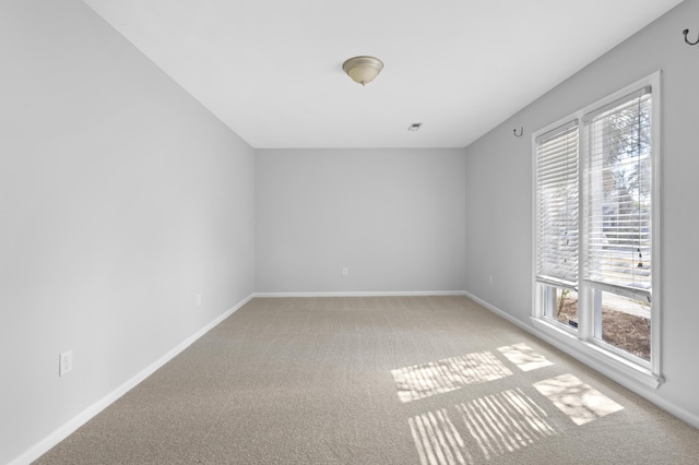 carpeted spare room featuring a healthy amount of sunlight