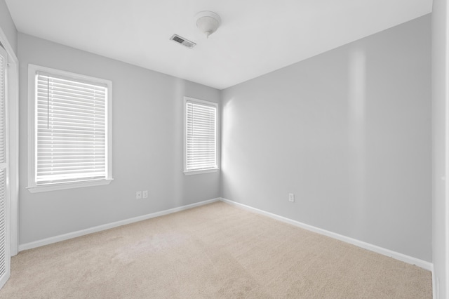 unfurnished room with light colored carpet