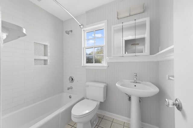 bathroom with toilet, tiled shower / bath combo, and tile patterned flooring