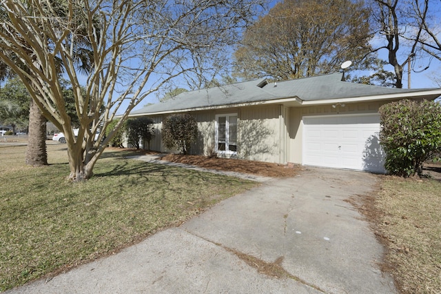 ranch-style home featuring a garage and a front yard