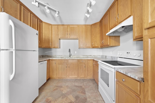 kitchen featuring light stone counters, sink, and white appliances