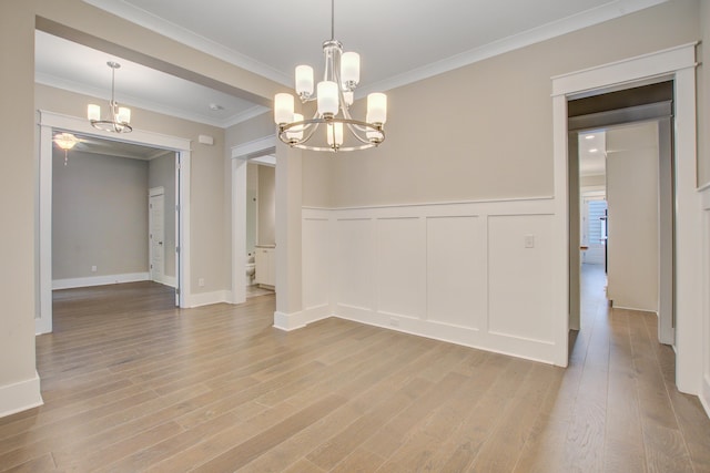 1363 Rivella Dr, Mount Pleasant, SC 29464 - empty room with a chandelier, light wood finished floors, ornamental molding, a decorative wall, and a wainscoted wall