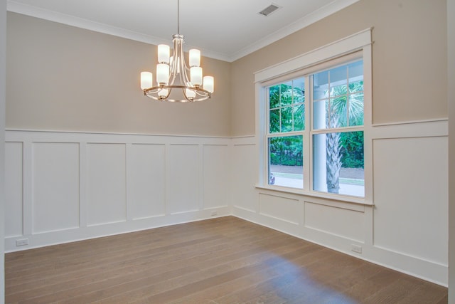 1363 Rivella Dr, Mount Pleasant, SC 29464 - unfurnished dining area with a decorative wall, a chandelier, wood finished floors, crown molding, and a wainscoted wall