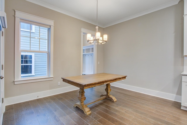 1363 Rivella Dr, Mount Pleasant, SC 29464 - unfurnished dining area with baseboards, a chandelier, wood finished floors, and crown molding