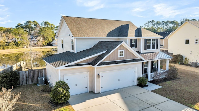 view of front facade with a garage, a porch, and cooling unit