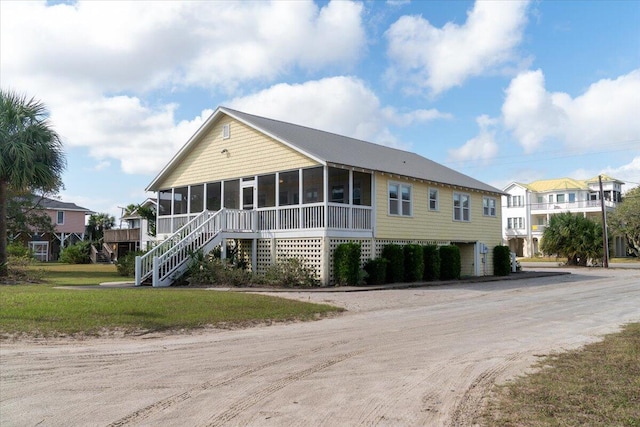 view of front of house featuring a sunroom