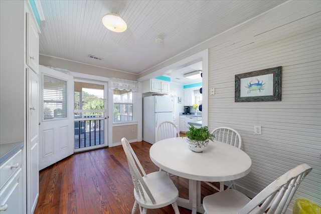 dining room featuring ornamental molding and dark wood-type flooring