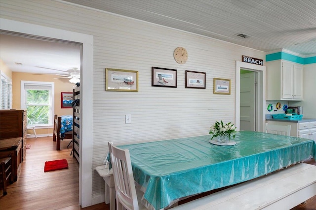 dining area with light hardwood / wood-style floors and ceiling fan