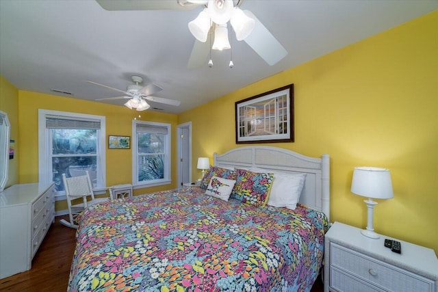 bedroom with dark hardwood / wood-style flooring and ceiling fan