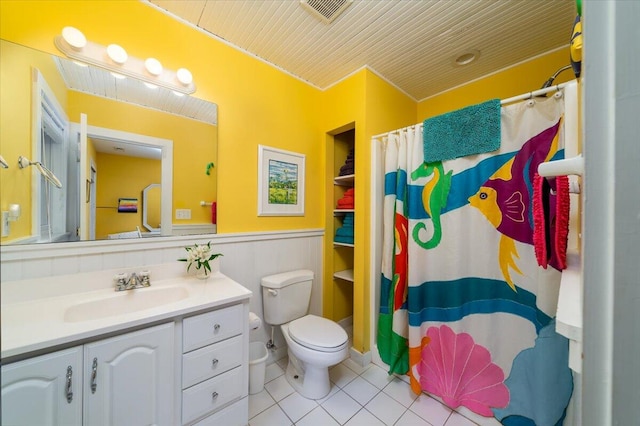 bathroom featuring toilet, vanity, and tile patterned floors