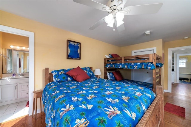 bedroom featuring wood-type flooring, ceiling fan, and ensuite bathroom