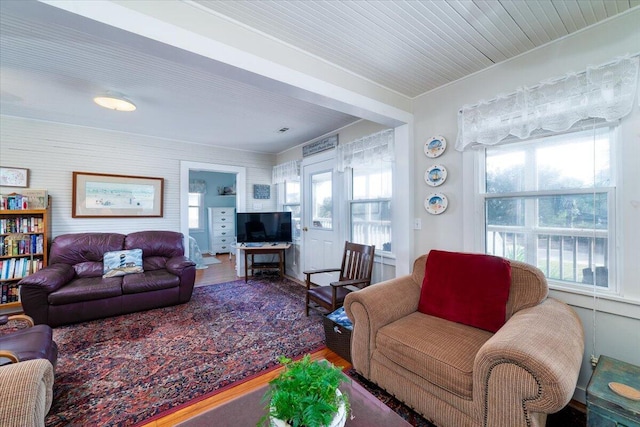 living room featuring hardwood / wood-style flooring and wood ceiling