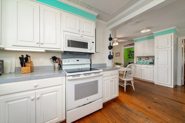 kitchen featuring white cabinetry, dark wood-type flooring, ornamental molding, and white appliances