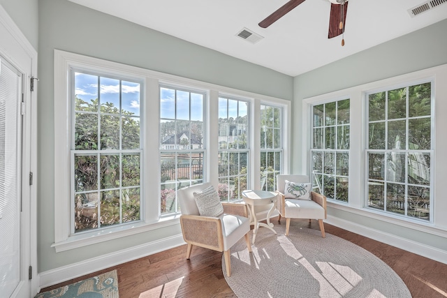 sunroom / solarium with ceiling fan and a healthy amount of sunlight