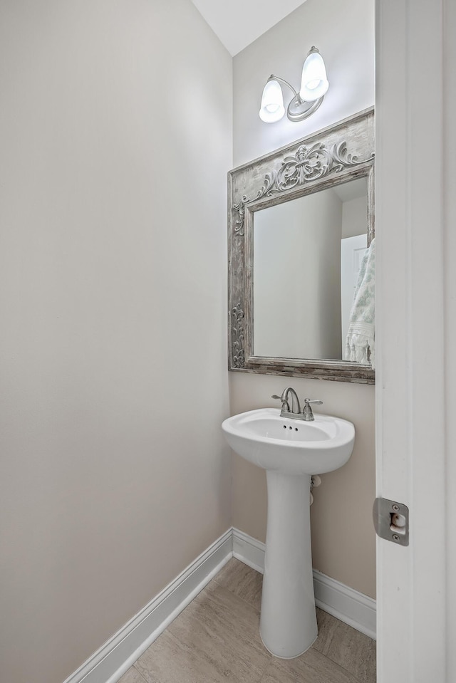 bathroom with sink and wood-type flooring