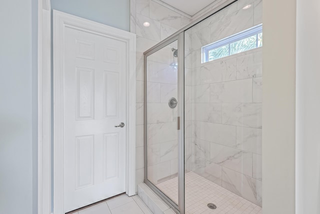 bathroom with tile patterned flooring and a shower with door