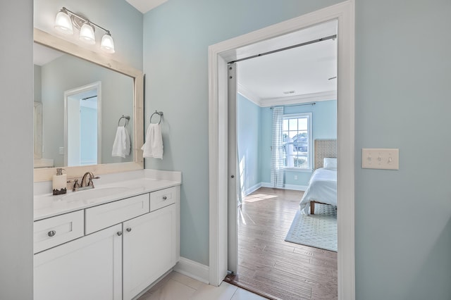 bathroom with vanity, wood-type flooring, and ornamental molding