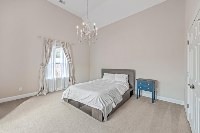 bedroom with a chandelier, light colored carpet, and lofted ceiling