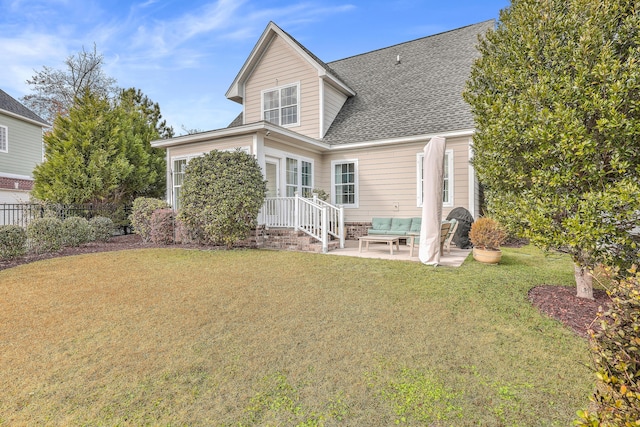 rear view of property featuring a yard and a patio