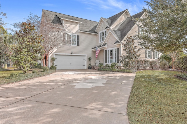 view of front of home featuring a front lawn and a garage