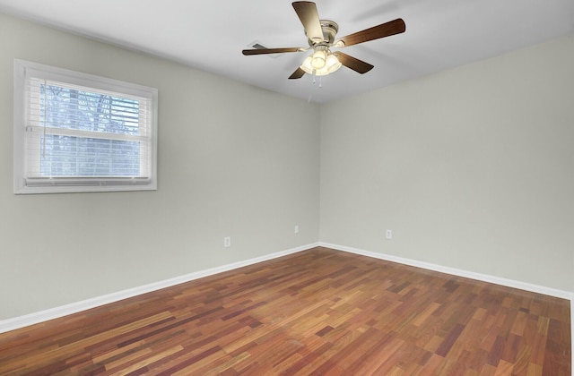 spare room with ceiling fan, baseboards, and wood finished floors