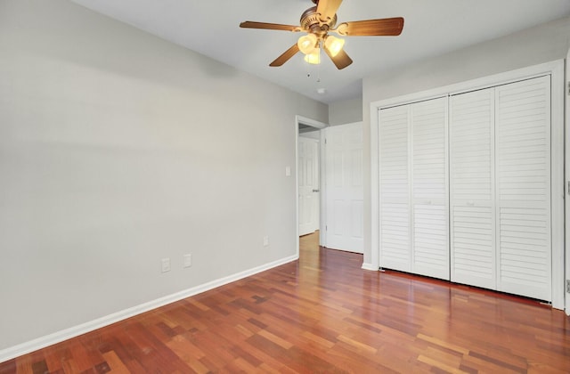 unfurnished bedroom with a ceiling fan, a closet, baseboards, and wood finished floors