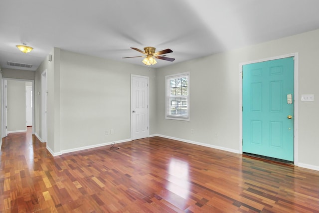 entrance foyer featuring a ceiling fan, visible vents, baseboards, and wood finished floors