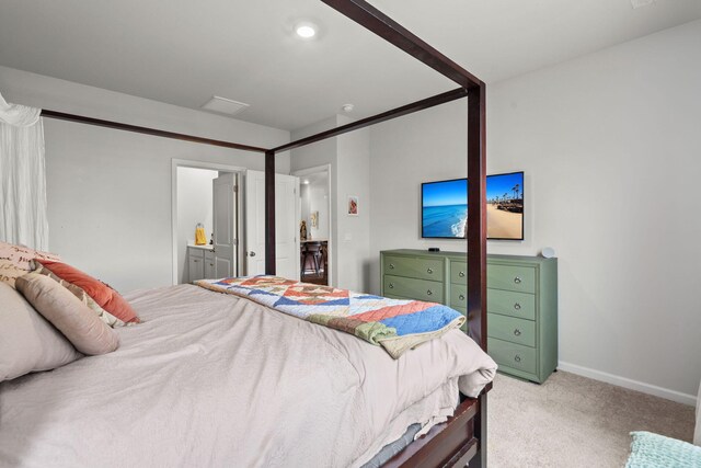 carpeted bedroom with ensuite bath