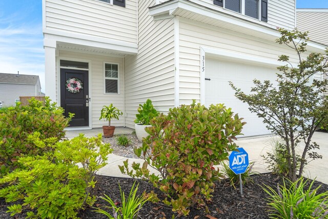 doorway to property with a garage