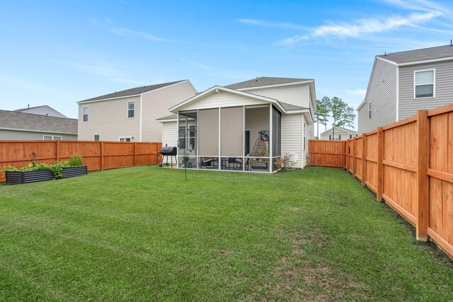 back of property with a sunroom and a lawn