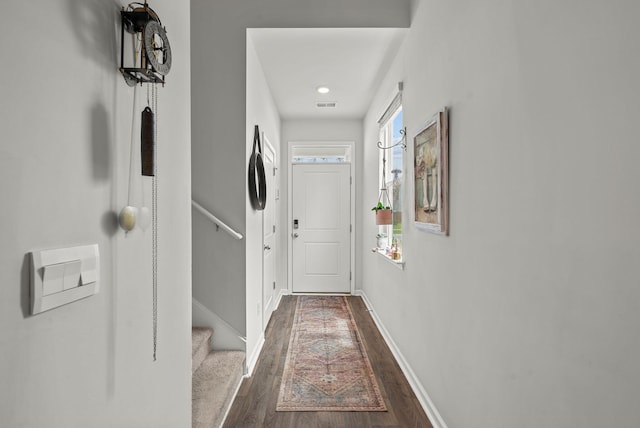 corridor with dark hardwood / wood-style flooring