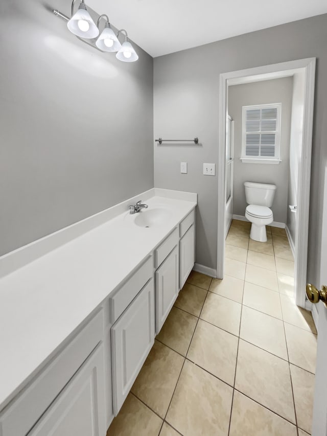 full bathroom featuring tile patterned flooring, vanity, toilet, and shower / bathtub combination