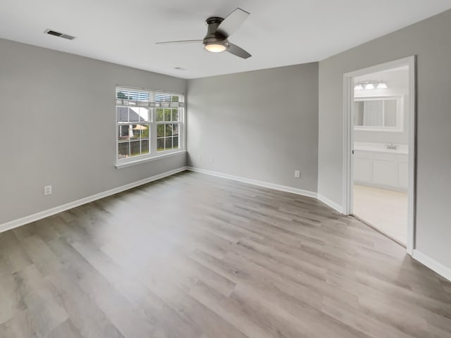 spare room featuring light hardwood / wood-style flooring, ceiling fan, and sink