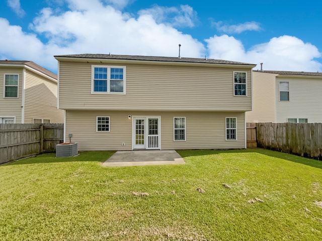 rear view of house featuring central air condition unit, a yard, and a patio