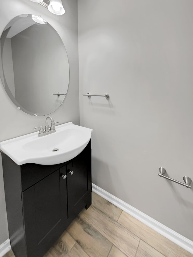 bathroom with vanity and hardwood / wood-style flooring