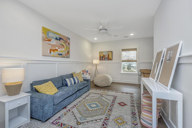 living room featuring ceiling fan and hardwood / wood-style floors