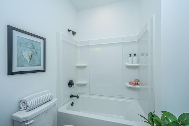 bathroom with washtub / shower combination and toilet