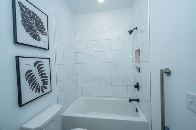 bathroom with tiled shower / bath combo and toilet