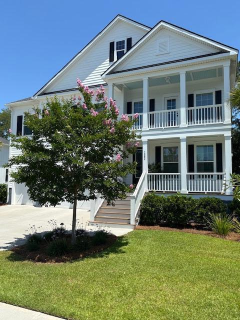 1562 Charming Nancy Rd, Charleston, SC 29412 - neoclassical home with covered porch, a front lawn, a balcony, and driveway